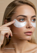 Close-up of woman applying under eye patches for skincare treatment