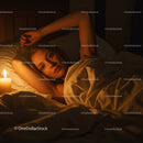 Woman Relaxing in Bed with Candles in a Cozy Atmosphere