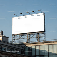Blank billboard on rooftop against clear blue sky