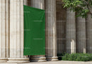 Ancient Stone Columns with Blank Green Banner Outdoors