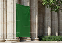 Ancient Stone Columns with Blank Green Banner Outdoors