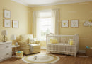 Bright Yellow Children's Bedroom with Cozy Armchair and Baby Cot