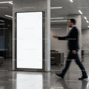 Businessman Walking Past Blank Digital Advertisement Poster