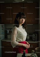 Young Woman in Lace Blouse and Red Skirt in Modern Kitchen