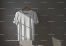 Minimalist white t-shirt hanging with natural light shadows