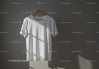 Minimalist white t-shirt hanging with natural light shadows