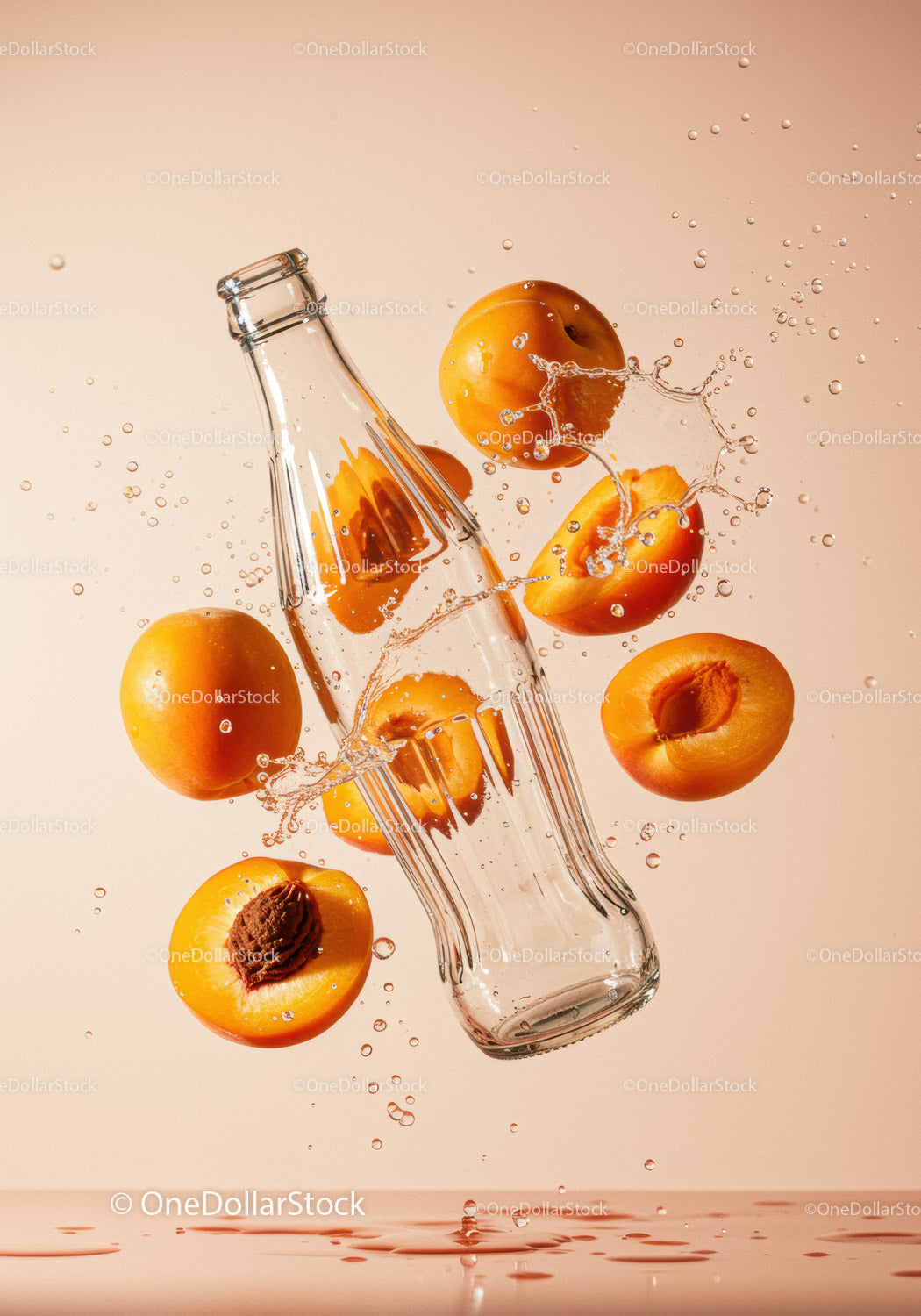 Fresh apricots splashing around glass bottle
