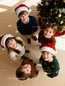 Smiling Children Wearing Santa Hats Near Christmas Tree