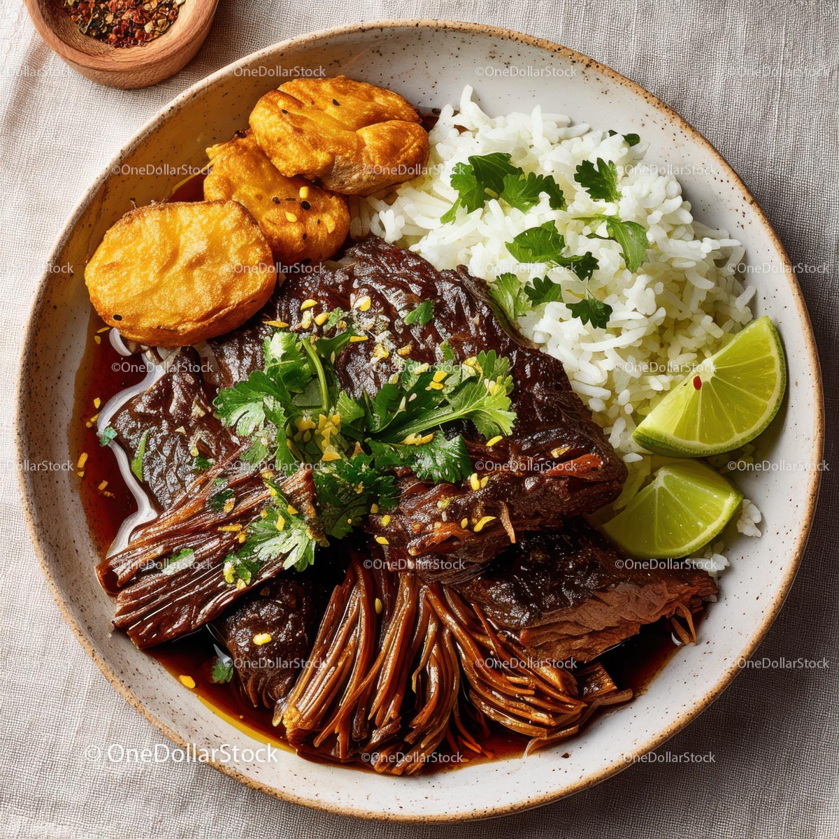 Savory Beef Dish with Rice, Plantains, and Fresh Lime Wedges