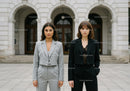 Stylish Businesswomen Standing Confidently in Front of Historic City Building