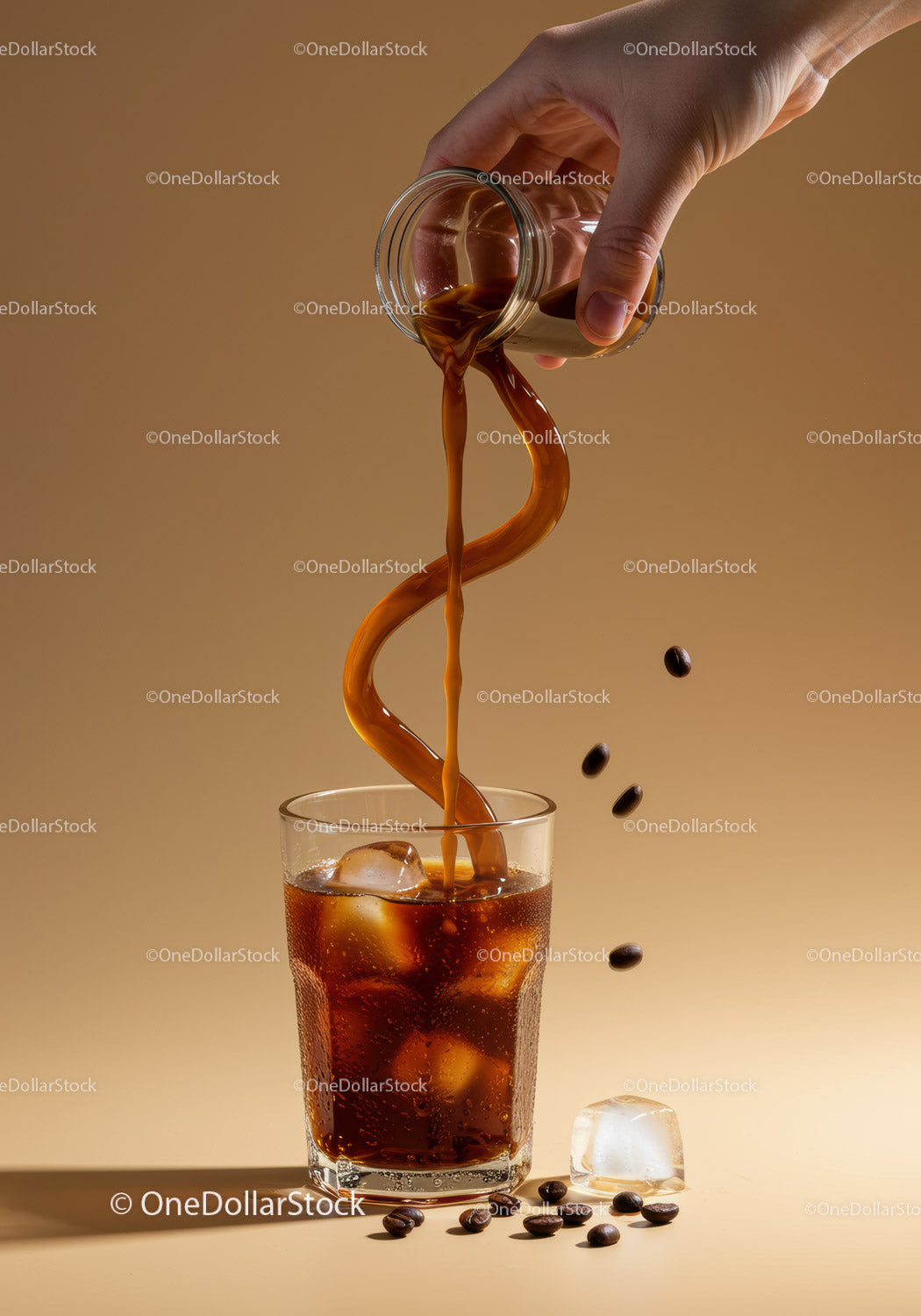 Refreshing iced coffee pouring into glass with ice cubes