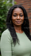 Confident woman with hoop earrings in casual green top