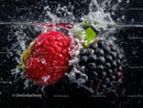Fresh Raspberries and Blackberries Splashing in Water