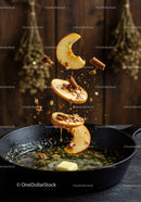 Sliced Apples Falling into Hot Skillet with Spices