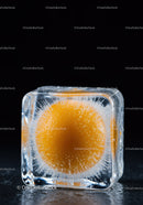 Orange sphere frozen inside a clear ice cube block