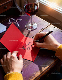 Writing a heartfelt love note with wine by the window