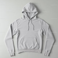 Minimalist White Hoodie Laid Flat on Gray Surface