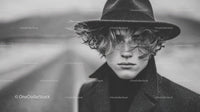 Black and White Fashion Portrait of Young Man with Curly Hair and Vintage Hat