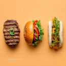 Gourmet Burger with Lettuce and Tomato Next to Grilled Steak and Dumpling