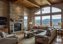 Cozy living room with stone fireplace and mountain view
