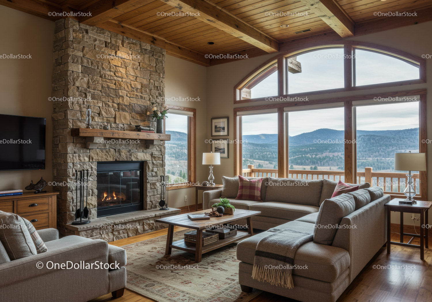 Cozy living room with stone fireplace and mountain view