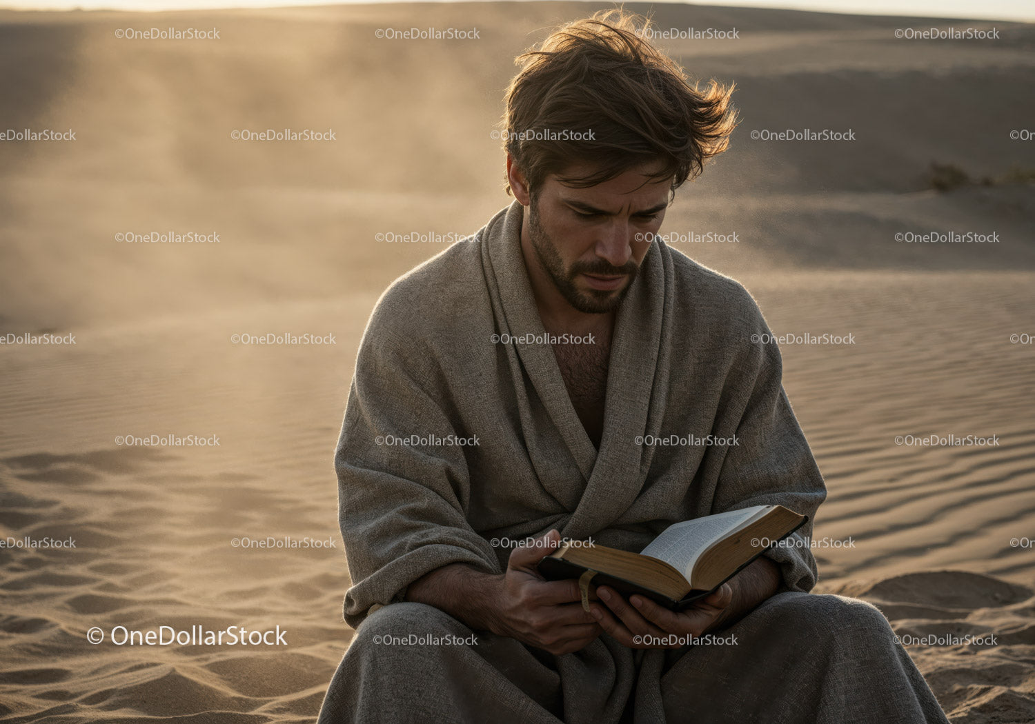 Man in Casual Clothing Reading a Book on Desert Sandy Landscape