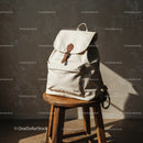 Minimalist white backpack on rustic wooden stool