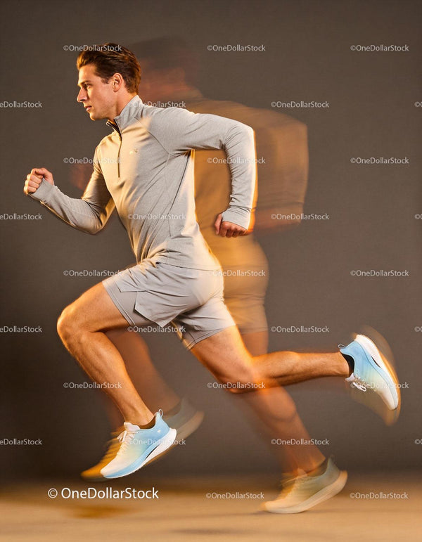 Athlete sprinting in motion blur effect against dark background