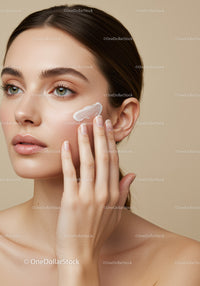 Elegant Woman Applying Skincare Cream for Flawless Skin