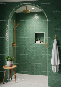 Modern green tiled shower with gold fixtures and wooden stool