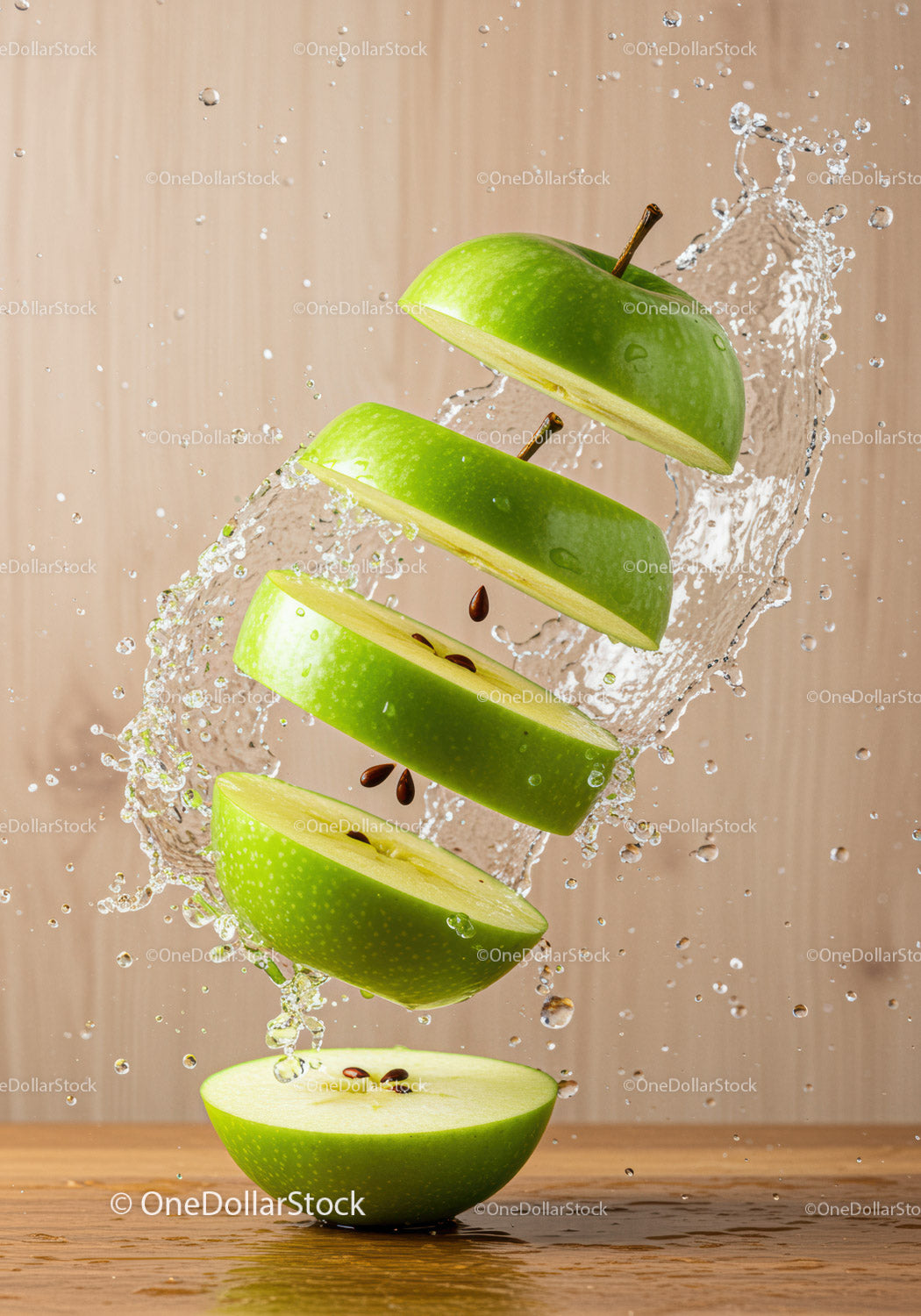 Fresh green apple slices suspended with water splash