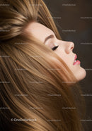 Side profile of a young woman with flowing blonde hair