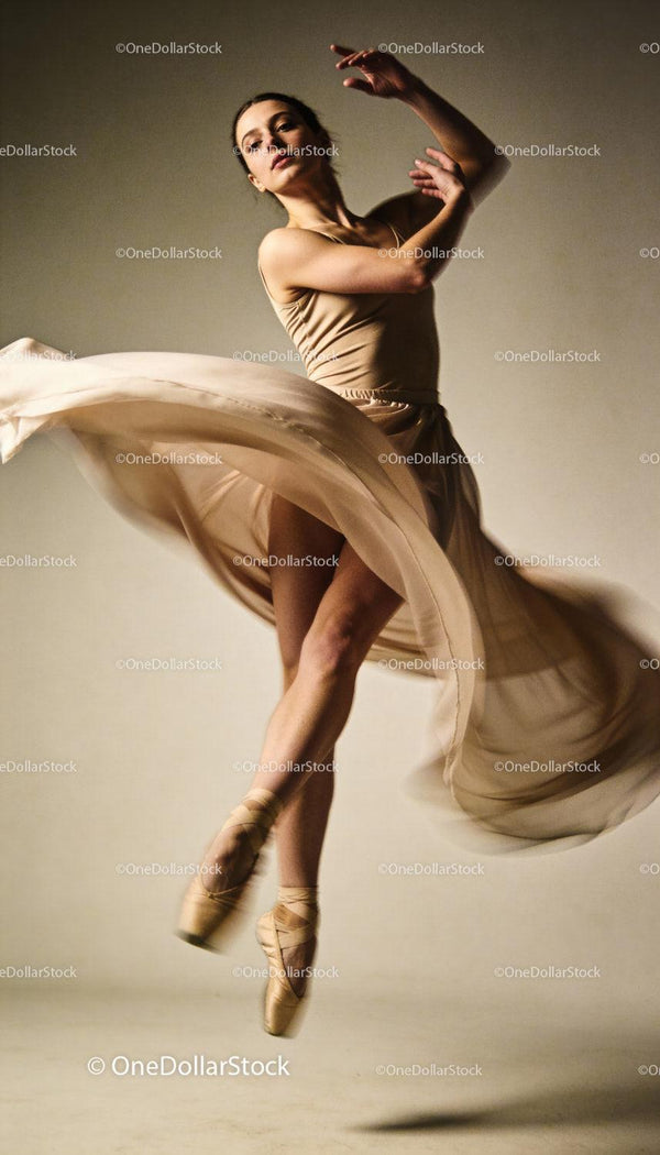 Graceful ballet dancer spinning in flowing dress
