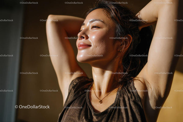 Joyful Woman Relaxing in Sunlight with Closed Eyes and Peaceful Expression