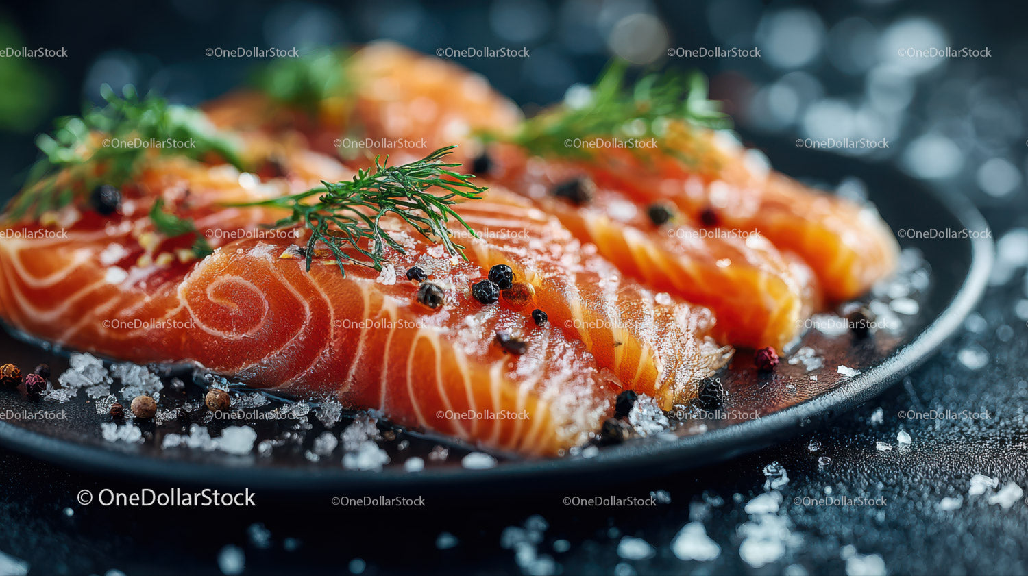 Fresh Sliced Smoked Salmon with Herbs and Sea Salt on Black Plate