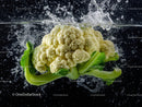 Fresh Cauliflower Head with Green Leaves on Black Water Background