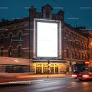 Historic building with illuminated blank billboard at dusk