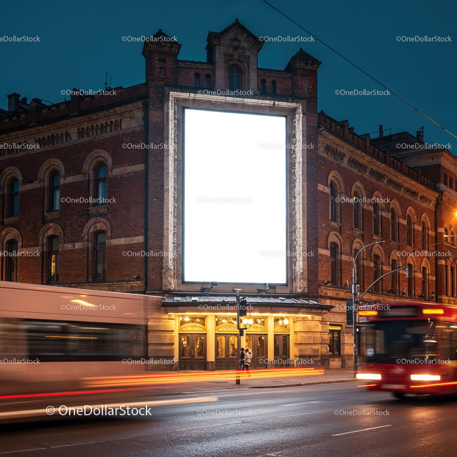 Historic building with illuminated blank billboard at dusk