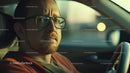 Man with Glasses Pensive Expression While Driving Car in Daylight