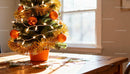 Small Christmas Tree with Golden Decorations on Table