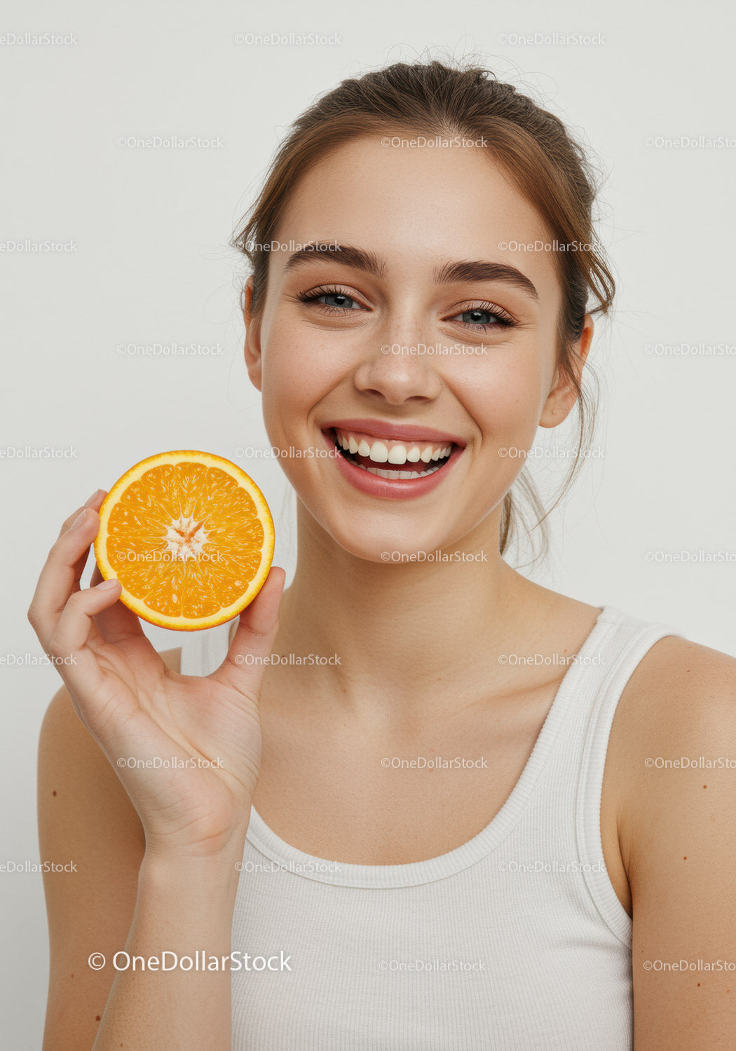 Young Woman Smiling Holding Fresh Orange Slice for Healthy Lifestyle