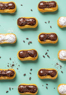 Mini eclairs with chocolate and powdered sugar topping