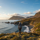Scenic Coastal Landscape with Hilltop Woman Backpacker at Sunset