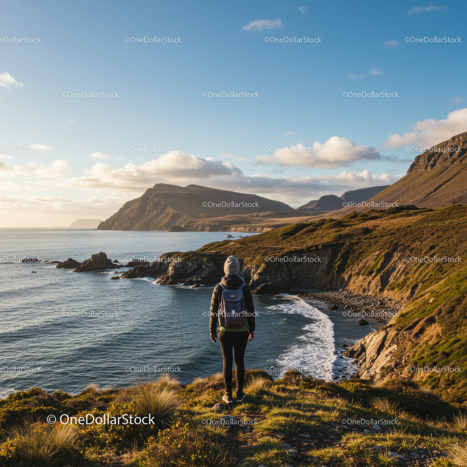 Scenic Coastal Landscape with Hilltop Woman Backpacker at Sunset