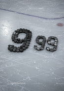 Numbers formed with hockey pucks on ice rink surface