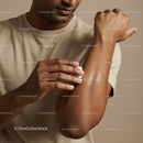 Man Applying Lotion to Arm for Skin Hydration and Care