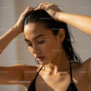 Elegant Woman with Wet Hair and Dewy Skin in Sunlit Portrait