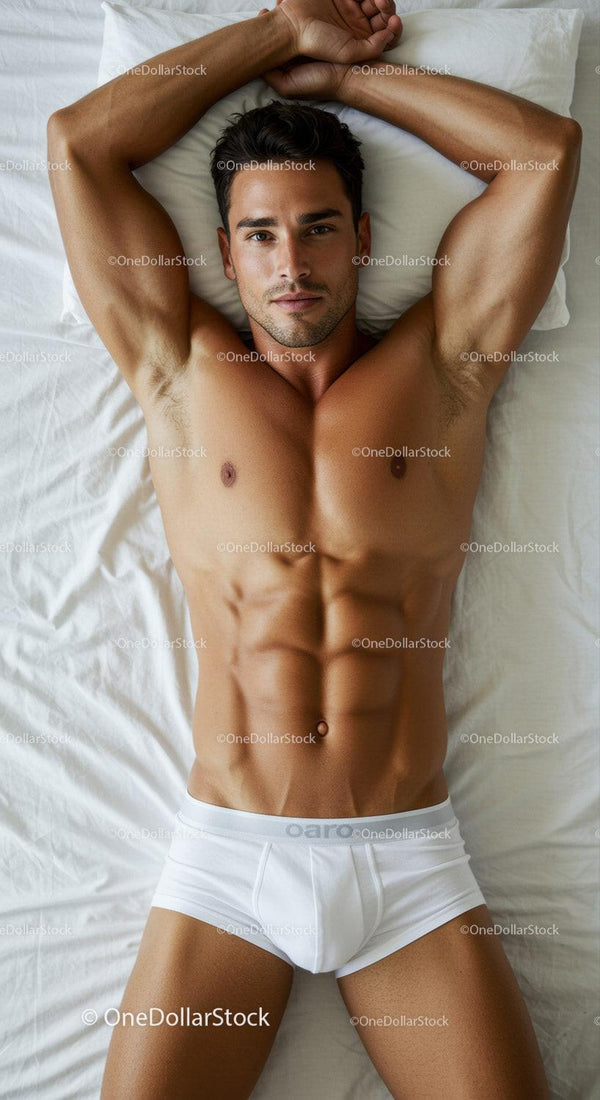 Fit Young Man Relaxing on Bed in White Underwear