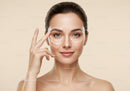 Woman Receiving Facial Massage for Skin Rejuvenation Near Beige Background