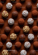 Assorted chocolate truffles with nuts and coconut flakes